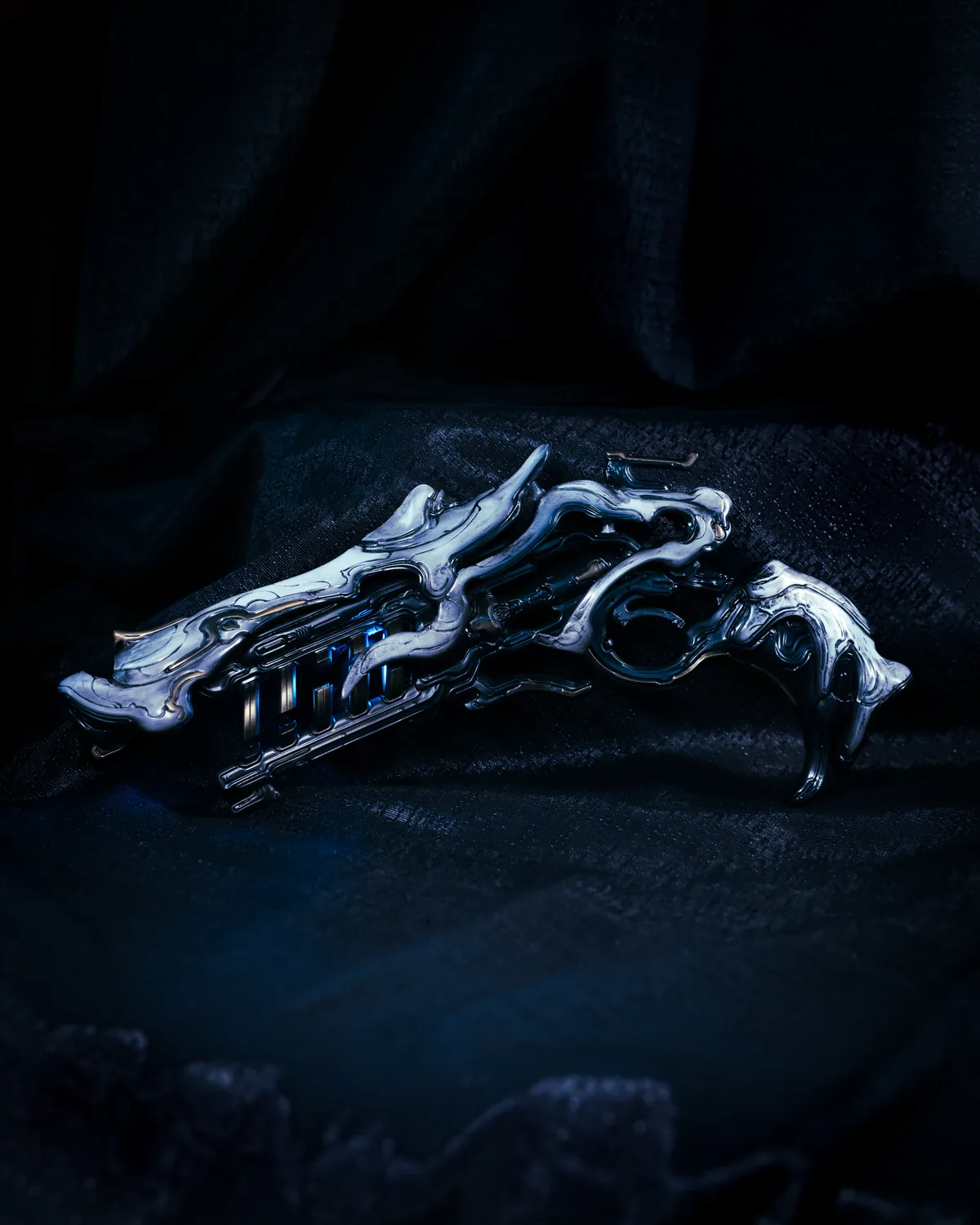The Warframe Sirocco sidearm built by Hoku Props, chrome finish on dark fabric